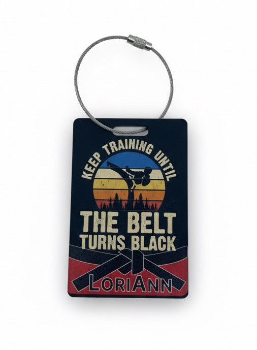 Bag Tag with 'Keep Training Until The Belt Turns Black' design on a Matte Black Acrylic Tag with a steel cable tie.
